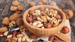 Why and for what purpose is it necessary to soak NUTS in hot water before eating them?